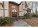Exterior view of front entry, with brick, steps and trimmed bushes at 6851 Ne Roswell Rd # C4, Atlanta, GA 30328