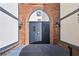 Classic building entrance with black doors and brick archway at 6851 Ne Roswell Rd # C4, Atlanta, GA 30328