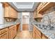 Bright kitchen boasting granite countertops, stainless steel sink, wooden cabinets, and wood flooring at 6851 Ne Roswell Rd # C4, Atlanta, GA 30328