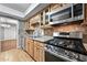 Well-equipped kitchen featuring stainless steel appliances, granite countertops, and stylish tile backsplash at 6851 Ne Roswell Rd # C4, Atlanta, GA 30328