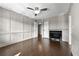 Cozy living room with a fireplace, hardwood floors, and bright lighting at 6851 Ne Roswell Rd # C4, Atlanta, GA 30328