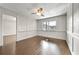 Bright living room boasts hardwood floors, a modern ceiling fan, and paneled walls at 6851 Ne Roswell Rd # C4, Atlanta, GA 30328