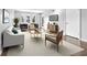 Inviting living room with hardwood floors, large windows, and stylish modern furniture at 6851 Ne Roswell Rd # C4, Atlanta, GA 30328