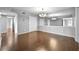 Spacious living area with hardwood floors, a large mirror, and modern light fixture at 6851 Ne Roswell Rd # C4, Atlanta, GA 30328