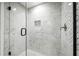 Modern shower featuring marble tiling, glass door, and new shower head and faucet at 6851 Ne Roswell Rd # C4, Atlanta, GA 30328