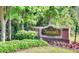 Entrance to Foxcroft Condominium with lush landscaping, flowers and clear signage at 6851 Ne Roswell Rd # C4, Atlanta, GA 30328