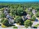 Neighborhood aerial showcasing lush tree coverage and proximity to city at 10635 Sugar Crest Ave, Johns Creek, GA 30097