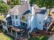Aerial view of a home with a spacious deck, screened porch, and well-manicured lawn at 10635 Sugar Crest Ave, Johns Creek, GA 30097