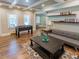Finished basement featuring a foosball table, gray sofa, and wood-look flooring at 10635 Sugar Crest Ave, Johns Creek, GA 30097