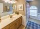 Bathroom with a white countertop vanity, a large mirror, and a shower at 10635 Sugar Crest Ave, Johns Creek, GA 30097