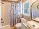 Cozy bathroom with a shower-tub combo, decorative shower curtain, granite countertop, and a modern sink at 10635 Sugar Crest Ave, Johns Creek, GA 30097