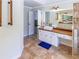Bathroom features wood countertop vanity and a walk-in shower with tiled surround at 10635 Sugar Crest Ave, Johns Creek, GA 30097