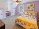 Bedroom featuring a yellow flower patterned bedspread, a desk, and natural light at 10635 Sugar Crest Ave, Johns Creek, GA 30097