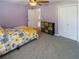 Bedroom featuring a yellow flower patterned bedspread, with patterned carpet flooring at 10635 Sugar Crest Ave, Johns Creek, GA 30097