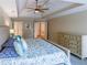 Bedroom with a blue patterned bedspread, a ceiling fan, and natural light at 10635 Sugar Crest Ave, Johns Creek, GA 30097