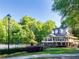 Elegant clubhouse with a porch, complemented by a pristine lawn and a swimming pool at 10635 Sugar Crest Ave, Johns Creek, GA 30097