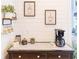 Coffee bar featuring a modern machine, decorative mugs, and coffee-themed wall art at 10635 Sugar Crest Ave, Johns Creek, GA 30097