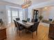 Dining room with bay window, hardwood floors, and modern lighting at 10635 Sugar Crest Ave, Johns Creek, GA 30097