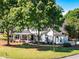 Charming home with a welcoming front porch, mature trees, and lush green lawn at 10635 Sugar Crest Ave, Johns Creek, GA 30097