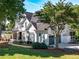 Beautiful two-story home featuring a covered front porch, manicured landscaping, and attached two-car garage at 10635 Sugar Crest Ave, Johns Creek, GA 30097
