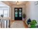 Inviting foyer with double doors, hardwood floors, and stylish decor at 10635 Sugar Crest Ave, Johns Creek, GA 30097