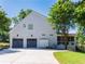Spacious two-car garage with a long driveway, complemented by well-maintained landscaping at 10635 Sugar Crest Ave, Johns Creek, GA 30097