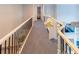 Hallway with white railings, bench, and carpeted flooring at 10635 Sugar Crest Ave, Johns Creek, GA 30097