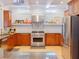 Gourmet kitchen featuring stainless steel appliances, tiled backsplash, and custom cabinetry at 10635 Sugar Crest Ave, Johns Creek, GA 30097