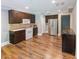 Traditional kitchen with dark wood cabinets, stainless steel appliances, and hardwood floors at 10635 Sugar Crest Ave, Johns Creek, GA 30097