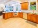 Well-lit kitchen featuring stainless steel appliances, a double sink, and wooden cabinetry at 10635 Sugar Crest Ave, Johns Creek, GA 30097