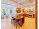 Open kitchen with island, granite countertops, wooden cabinets, and stainless steel appliances at 10635 Sugar Crest Ave, Johns Creek, GA 30097