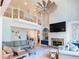 Bright living room with fireplace, stone surround, built-in shelving, and large windows at 10635 Sugar Crest Ave, Johns Creek, GA 30097