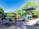 Vibrant playground with swings and slides, surrounded by lush greenery at 10635 Sugar Crest Ave, Johns Creek, GA 30097