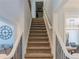 Carpeted staircase with white railing and wrought iron spindles at 10635 Sugar Crest Ave, Johns Creek, GA 30097
