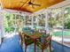 Inviting sunroom with screened windows, a ceiling fan, and an outdoor dining set at 10635 Sugar Crest Ave, Johns Creek, GA 30097