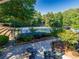 Scenic tennis courts and player seating areas with manicured landscaping at 10635 Sugar Crest Ave, Johns Creek, GA 30097