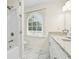 Bright bathroom featuring granite countertops, double sinks, and a shower-tub combination at 2040 Sunrise Cir, Cumming, GA 30040