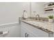 Bathroom with granite countertop, white cabinets and brushed nickel hardware; features a stylish, modern sink at 2040 Sunrise Cir, Cumming, GA 30040