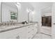 Modern bathroom featuring double sinks, granite countertops, white cabinetry, and a glass-enclosed shower at 2040 Sunrise Cir, Cumming, GA 30040