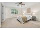 Bedroom featuring light wood flooring, a ceiling fan, and large windows, creating a bright and inviting space at 2040 Sunrise Cir, Cumming, GA 30040