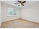 Bedroom featuring hardwood floors, a ceiling fan, and a bright window bringing in natural light at 2040 Sunrise Cir, Cumming, GA 30040