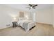 Cozy bedroom with a ceiling fan and light wood flooring. Features include a bed, lamps, and wall art at 2040 Sunrise Cir, Cumming, GA 30040