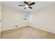 Bedroom showcasing beautiful flooring, a ceiling fan, and a window offering ample natural light at 2040 Sunrise Cir, Cumming, GA 30040