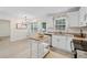 This bright kitchen offers white cabinets, stainless steel appliances, granite countertops, and a convenient kitchen island at 2040 Sunrise Cir, Cumming, GA 30040