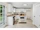 Well-lit kitchen with white cabinets, granite countertops, stainless steel appliances, and a convenient center island at 2040 Sunrise Cir, Cumming, GA 30040