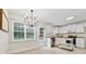 Bright kitchen featuring white cabinetry, modern appliances, ample counter space, and a cozy dining area at 2040 Sunrise Cir, Cumming, GA 30040