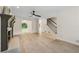 Open-concept living room with fireplace, staircase, and hardwood floors at 2040 Sunrise Cir, Cumming, GA 30040