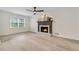 Bright living room with a decorative fireplace, large window, neutral walls, and modern flooring at 2040 Sunrise Cir, Cumming, GA 30040