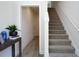 Hallway with stairs with carpet and wood flooring leading into a hallway at 4958 Villager Ln, Stone Mountain, GA 30083