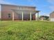 The backyard offers a covered patio, a grassy lawn, and space to play or entertain at 1477 Harlequin Way, Stockbridge, GA 30281